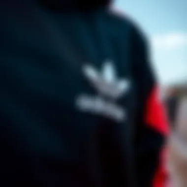 Close-up of Adidas logo on black tracksuit