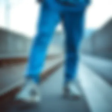 Adidas blue tracksuit bottoms paired with casual sneakers