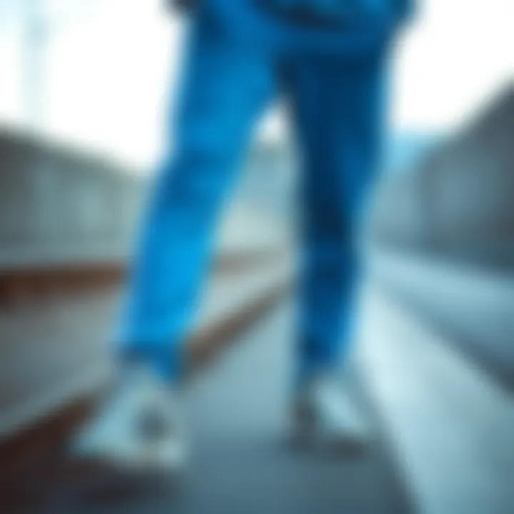 Adidas blue tracksuit bottoms paired with casual sneakers