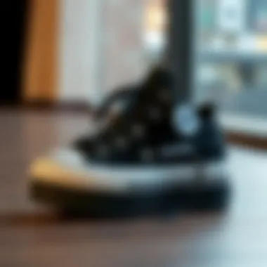 Stylish black Converse platform shoes on a wooden surface