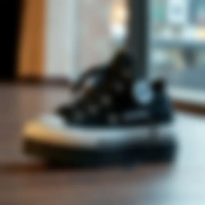 Stylish black Converse platform shoes on a wooden surface