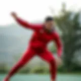Dynamic pose of a person wearing a red Adidas tracksuit during a workout session