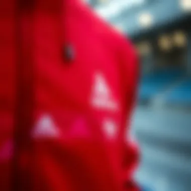 Close-up of the fabric and stitching details of a red Adidas tracksuit